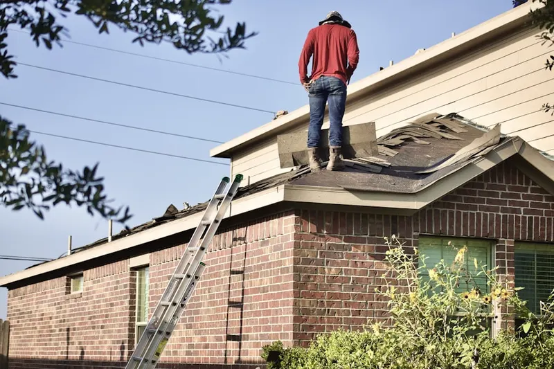 Professional roofer working on a residential roof in Golden Gate